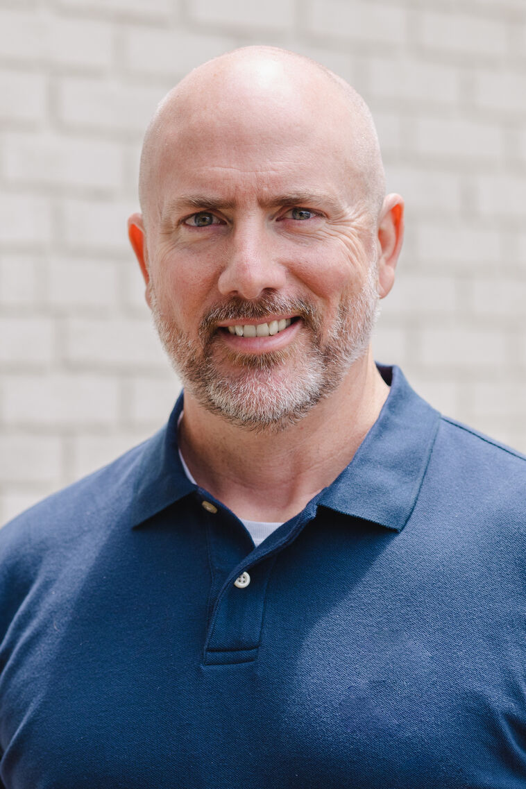 Therapist Chris Wells smiling at the camera.